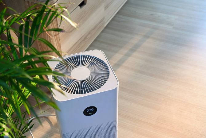 Air purifier on wooden floor in comfortable home. Fresh air and healthy life.